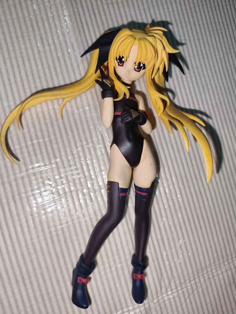 Fate Testarossa Nanoha Strike Collection PVC Anime Figure (Category: Figurines & Statues) located in Manila. Submitted by reascheyss51406 (Listing ID 1468335922, Image 1). Description: - Character: Fate Testarossa from Magical Girl Lyrical Nanoha - Appearance: Blonde twin-tails with black ribbons, black bodysuit, thigh-high stockings, and dark boots - Condition: Minor paint wear spots, strictly displayed on a shelf away from direct sunlight - Pac