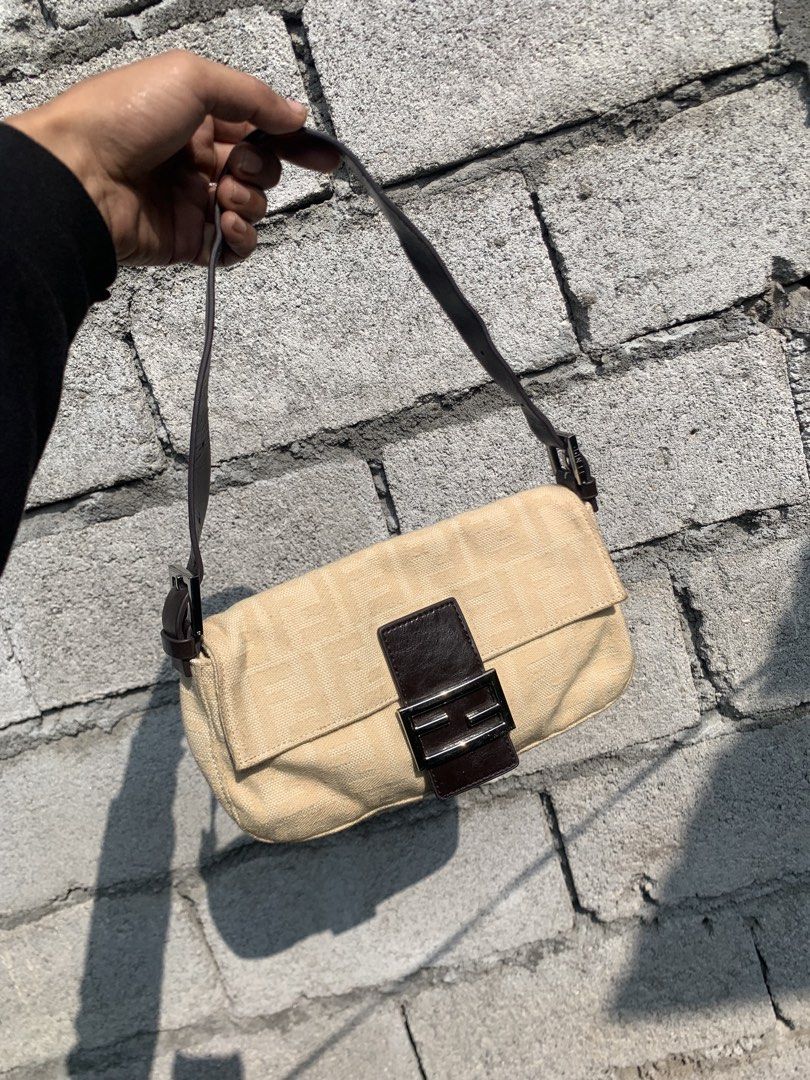 Fendi Baguette Shoulder bag (Category: Luxury Bags & Wallets) located in Polomolok. Submitted by domingthriftclothes (Listing ID 1468346695, Image 1). Description: - Brand: Fendi - Style: Zucchino Canvas Baguette Bag - Color: Beige canvas with dark brown leather strap and flap - Hardware: Silver-tone with engraved Fendi branding - Closure: Magnetic snap button - Strap: Adjustable shoulder strap - Condition: Clean exterior and sturdy vintage const
