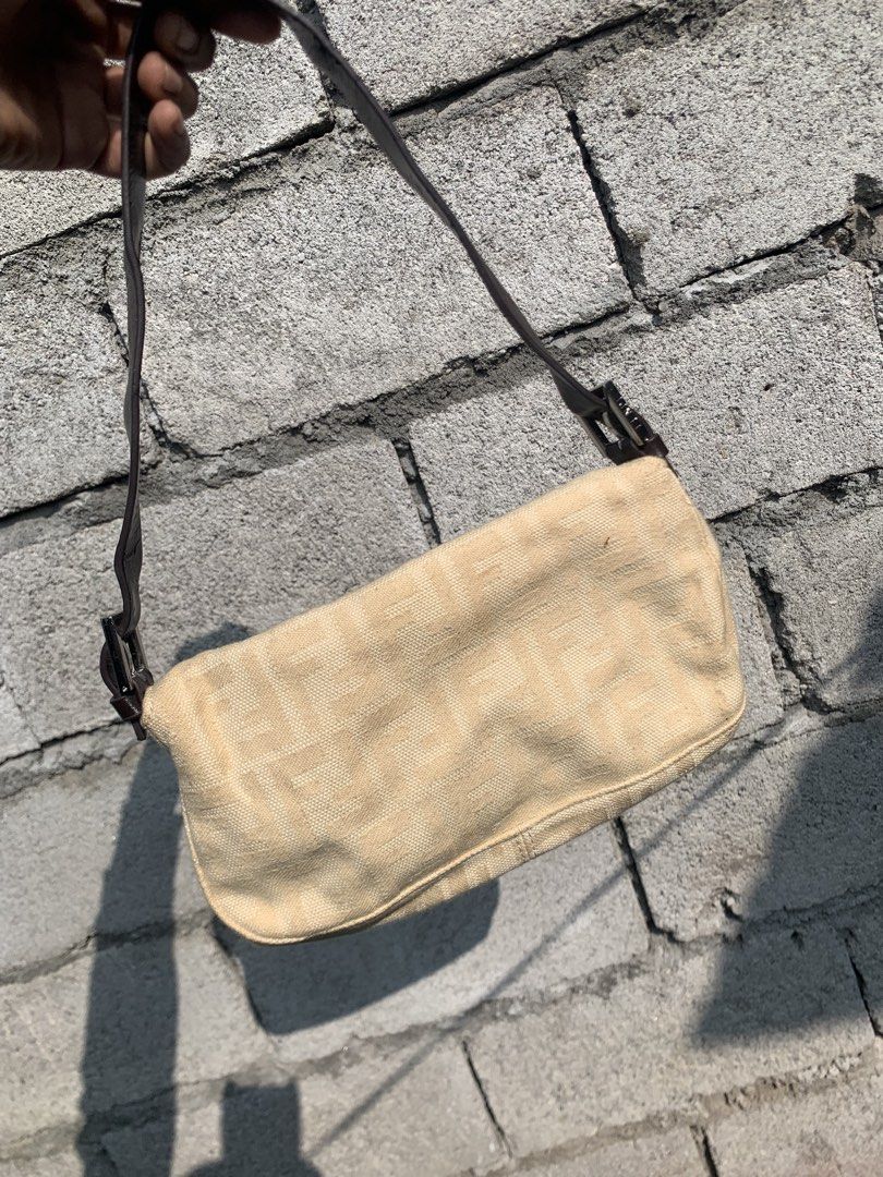 Fendi Baguette Shoulder bag (Category: Luxury Bags & Wallets) located in Polomolok. Submitted by domingthriftclothes (Listing ID 1468346695, Image 3). Description: - Brand: Fendi - Style: Zucchino Canvas Baguette Bag - Color: Beige canvas with dark brown leather strap and flap - Hardware: Silver-tone with engraved Fendi branding - Closure: Magnetic snap button - Strap: Adjustable shoulder strap - Condition: Clean exterior and sturdy vintage const