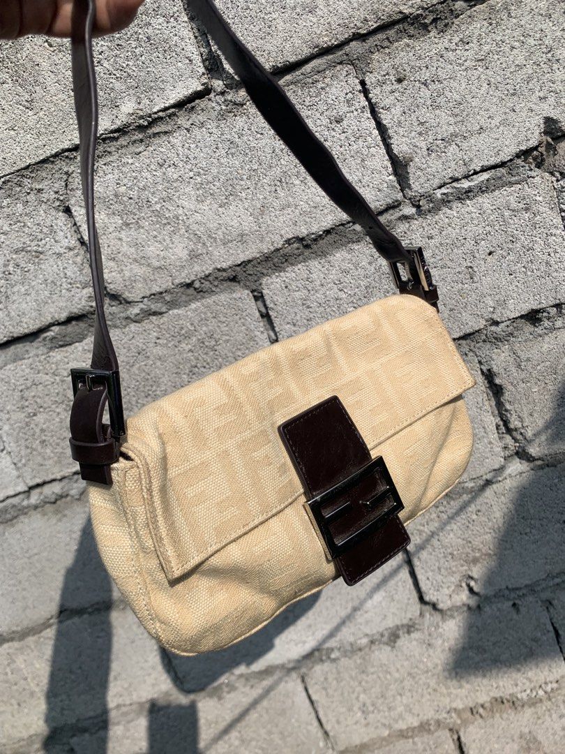 Fendi Baguette Shoulder bag (Category: Luxury Bags & Wallets) located in Polomolok. Submitted by domingthriftclothes (Listing ID 1468346695, Image 2). Description: - Brand: Fendi - Style: Zucchino Canvas Baguette Bag - Color: Beige canvas with dark brown leather strap and flap - Hardware: Silver-tone with engraved Fendi branding - Closure: Magnetic snap button - Strap: Adjustable shoulder strap - Condition: Clean exterior and sturdy vintage const