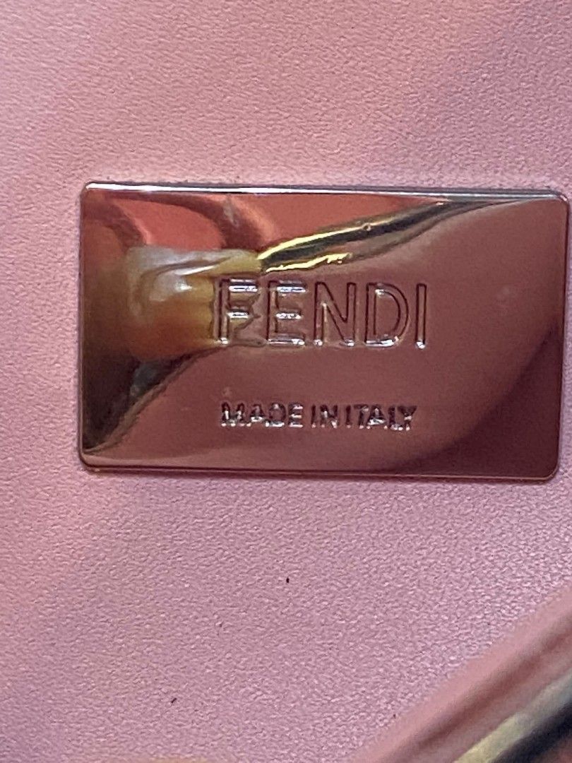 Fendi Leather Shoulder Bag with Orange Trim (Category: Luxury Bags & Wallets) located in Manila. Submitted by boldfire_315559 (Listing ID 1468303341, Image 3). Description: - Authentic Fendi shoulder bag in classic black leather - Eye-catching bright orange trim details along the straps and edges - Secure silver-tone hardware lock closure engraved with the iconic Fendi logo - Luxurious pink leather interior lining with a 'Made in Italy' metal log