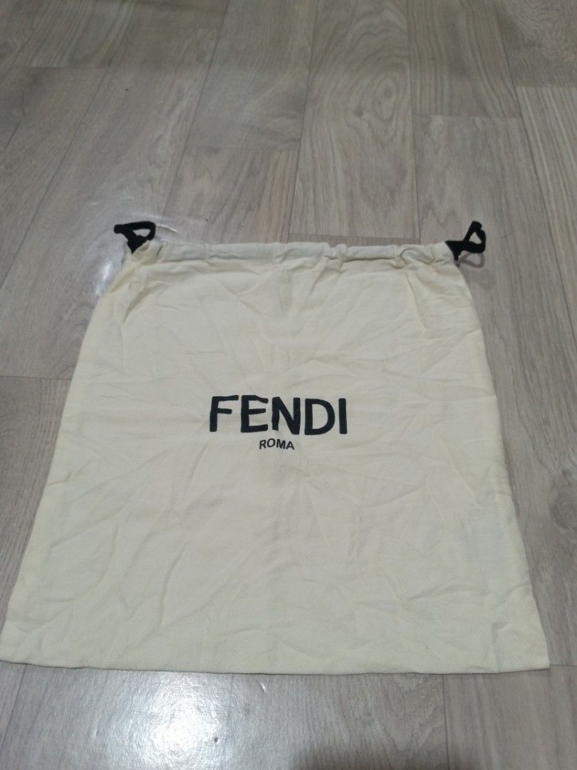 Fendi Roma Dust Bag Drawstring Pouch (Category: Luxury Bags & Wallets) located in Digos. Submitted by jenepiisid83759 (Listing ID 1468391978, Image 1). Description: - Authentic Fendi Roma dust bag - Color: Cream fabric with bold black lettering - Closure: Convenient black drawstring - 12x11.5inches - Details: Internal care tag with Italian/English text and recycling symbols.