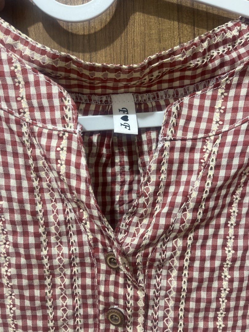F&F Red Gingham Check Button Blouse Top (Category: Blouses) located in Tabaco. Submitted by mcsizzlinghottocino (Listing ID 1468425830, Image 2). Description: - Brand: F&F - Design: Red and white gingham check with embroidered vertical stripes - Fit: Relaxed, lightweight, and comfortable - Neckline: V-neck with small button placket - Sleeves: Short sleeves - Condition: Excellent / Great for casual everyday wear - Mode of Payment: BPI / GCash / CO