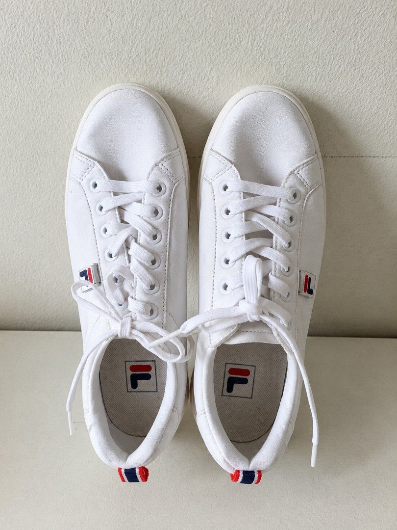Fila White Casual Sneakers (Category: Sneakers) located in Manila. Submitted by maxinesotto (Listing ID 1468309644, Image 1). Description: - Brand: Fila - Style: Classic white leather sneakers with iconic blue and red logo plate - Size: US 6 / EUR 36.5 - Features: Lace-up closure, striped pull tab at the heel, and grippy rubber sole - Condition: Clean upper, versatile everyday kicks - Mode of Payment: GCash, BPI, or BDO - Shipping: Via J&T Expres