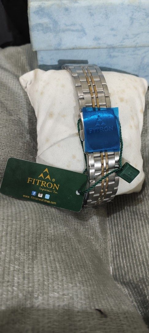 Fitron Quartz Two-Tone Men's Watch 9193M (Category: Men's Watches) located in Manila. Submitted by burgerpatti (Listing ID 1468462941, Image 3). Description: - Brand: Fitron Japan Quartz Watch (Model 9193M) - Design: Textured dark dial with gold bezel and date window at 3 o'clock - Strap: Two-tone silver and gold stainless steel bracelet - Build: Stainless steel back, water resistant - Inclusions: Complete with original blue box, tags, and produc
