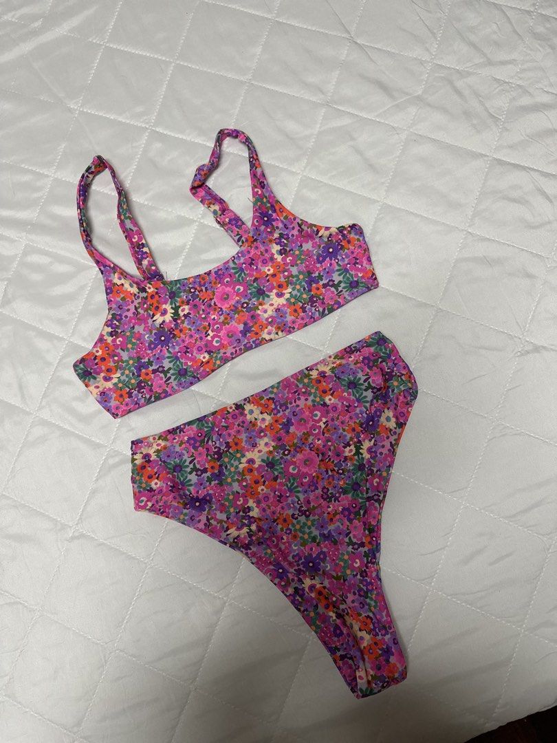 Floral Print Two-Piece Bikini High-Waisted (Category: Bikinis & Swimsuits) located in Valenzuela. Submitted by prelovedbyramsie (Listing ID 1468409508, Image 1). Description: - Style: Two-piece bikini set with high-waisted bottoms and a scoop neck crop top - Design: Vibrant floral pattern in purple, pink, and orange - Features: Adjustable straps for a customized fit and flattering cut - Material: Stretchy, comfortable swim fabric - Condition: Cle