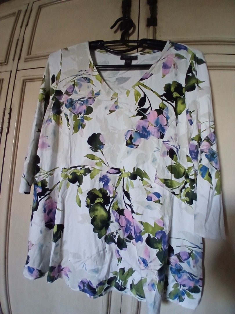 Floral Summer Top Lightweight V-Neck Blouse (Category: Blouses) located in Manila. Submitted by f.s_prelov3d (Listing ID 1468351009, Image 2). Description: - Style: Summer floral top - Design: Blue and purple floral pattern with green leaves on a crisp white base - Fit: Loose, flowy, and comfortable - Features: V-neckline and three-quarter sleeves - Material: Lightweight, breathable cotton/linen blend - Versatility: Pairs easily with jeans, short
