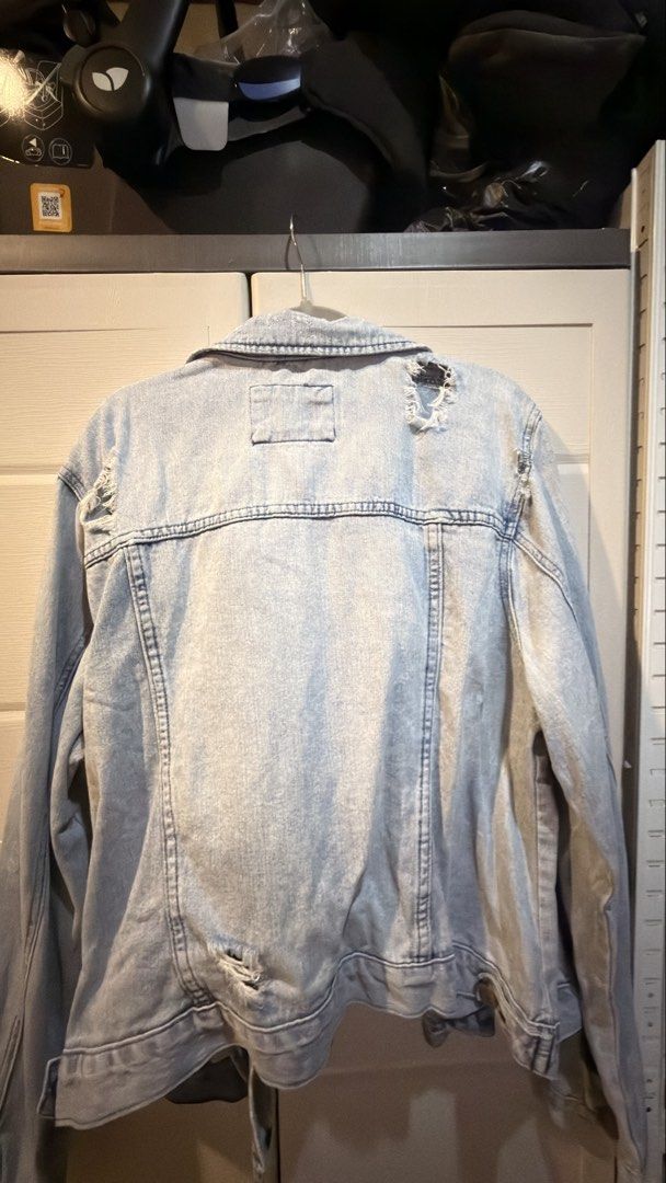 Forever 21 Light Wash Distressed Denim Jacket Plus Size (Category: Coats, Jackets and Outerwear) located in Manila. Submitted by adoptmypreloveditems (Listing ID 1468477727, Image 1). Description: - Brand: Forever 21 (Plus Size) - Style: Light wash denim jacket with distressed details on the back and hem - Features: Button-up front, classic collar, dual chest pockets, and side pockets - Fit: Comfortable plus size fit, great for layering on cooler