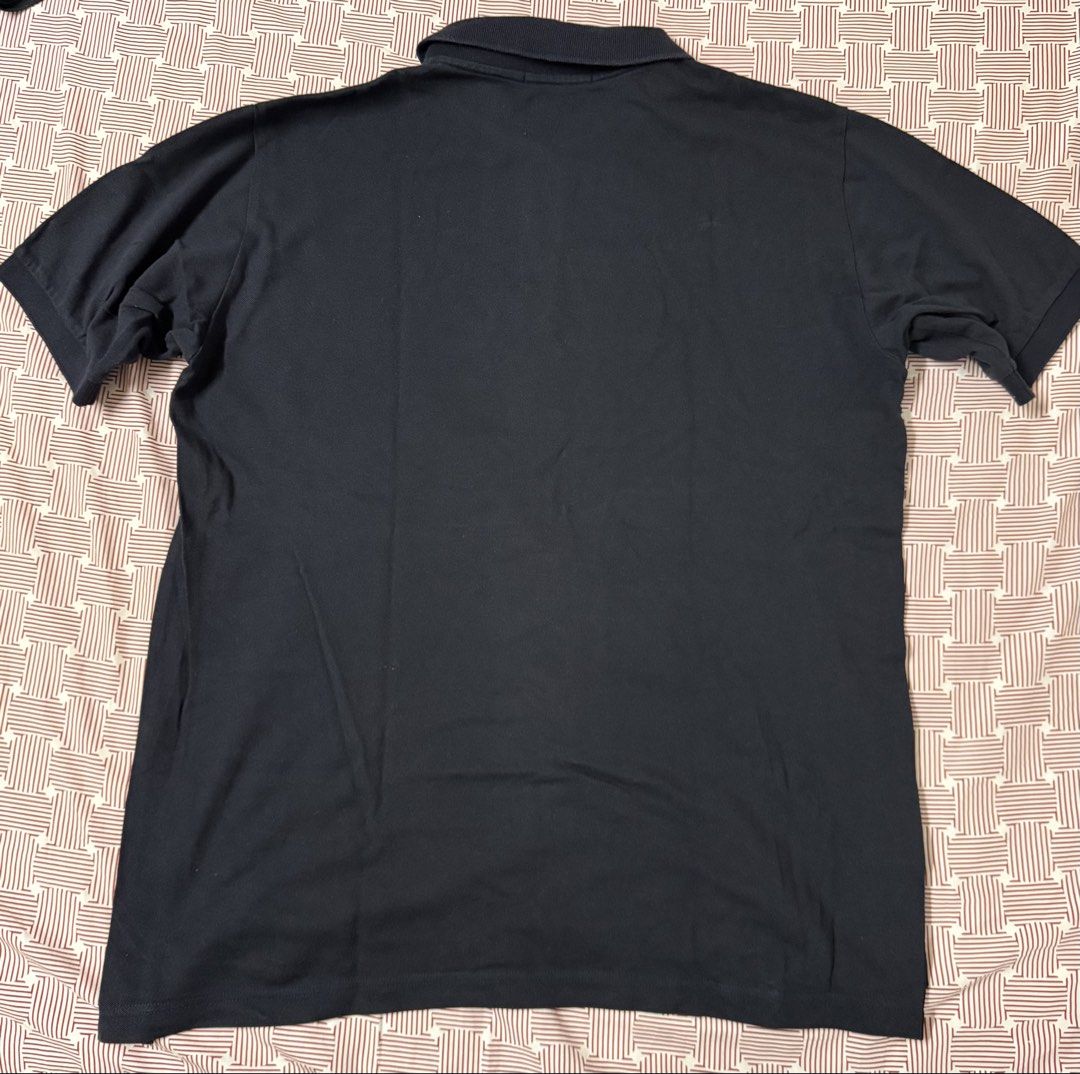 Fred Perry Black Polo Shirt Size L (Category: Tshirts & Polo Shirts ) located in Quezon City. Submitted by apm269 (Listing ID 1468295628, Image 2). Description: - Brand: Fred Perry - Color: Solid Black - Size: L (Tag on collar) - Material: 100% Cotton body - Details: Classic embroidered laurel wreath logo on the chest, button placket, and side slits with laurel tape detail near the hem - Condition: Clean fabric finish with care tag intact - width