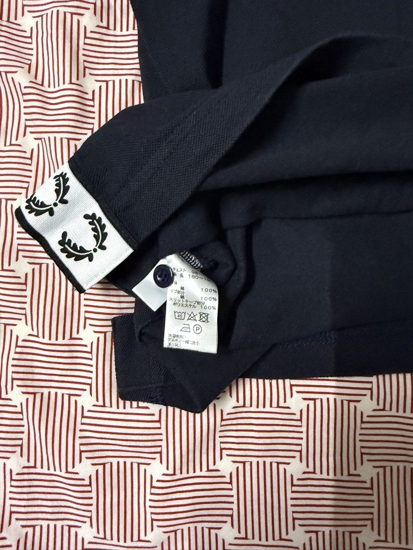 Fred Perry Black Polo Shirt Size L (Category: Tshirts & Polo Shirts ) located in Quezon City. Submitted by apm269 (Listing ID 1468295628, Image 3). Description: - Brand: Fred Perry - Color: Solid Black - Size: L (Tag on collar) - Material: 100% Cotton body - Details: Classic embroidered laurel wreath logo on the chest, button placket, and side slits with laurel tape detail near the hem - Condition: Clean fabric finish with care tag intact - width