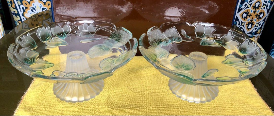 Frosted glass leaf design pedestal cake stands pair (Category: Dinnerware & Cutlery) located in Quezon City. Submitted by may.reyes (Listing ID 1468298170, Image 1). Description: - Pair of matching glass pedestals - Frosted ribbed bases with scalloped edges - Clear glass tops decorated with molded green leaf and flower motifs - Heavy and durable build - Ideal for display or serving desserts - Thoroughly cleaned and ready for use.