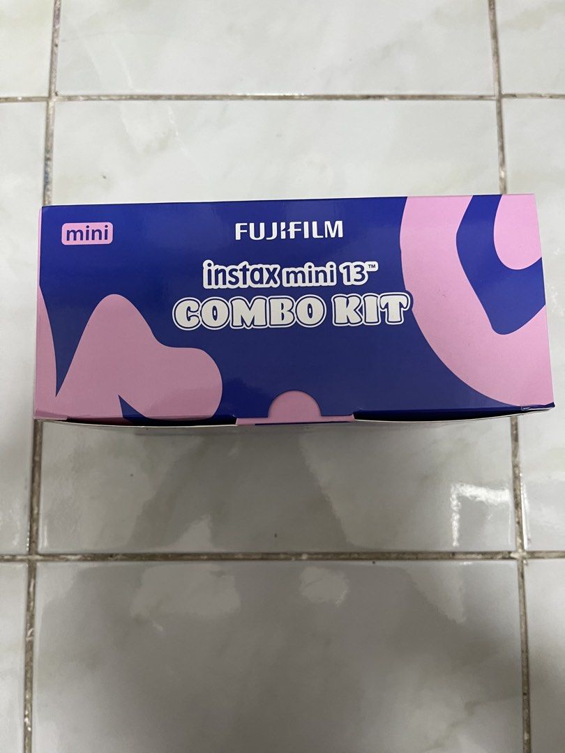 Fujifilm Instax Mini 13 Blue Combo Kit (Category: Cameras) located in Quezon City. Submitted by luckybounce_j8 (Listing ID 1468290931, Image 2). Description: - Item: Fujifilm Instax Mini 13 Instant Camera (Blue) - Condition: Brand new, factory-sealed in box (Harvey Norman) - Bundle: Complete combo kit with the camera + 2 packs of assorted Instax Mini film - Key Features: Automatic exposure, auto flash control, self-timer, and camera angle adjustm