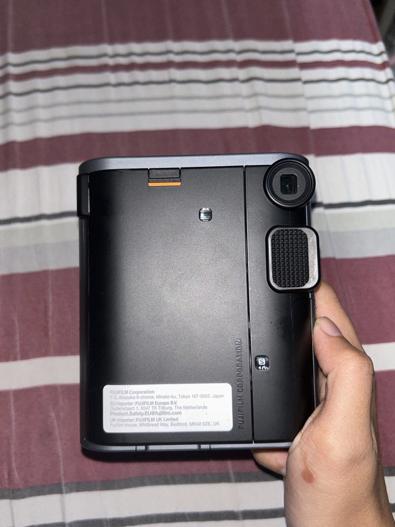 Fujifilm Instax Mini 41 Instant Camera (Category: Cameras) located in Manila. Submitted by 444vincci (Listing ID 1468487002, Image 2). Description: - Model: Fujifilm Instax Mini 41 Instant Camera - Color: Sleek Dark Grey with a textured grip handle - Lens: 60mm Instax lens (0.3m to infinity focus range) - Key Features: Built-in flash, close-up mode, and easy switch operation - Display: Rear film counter display - Power: Battery-operated - Conditi