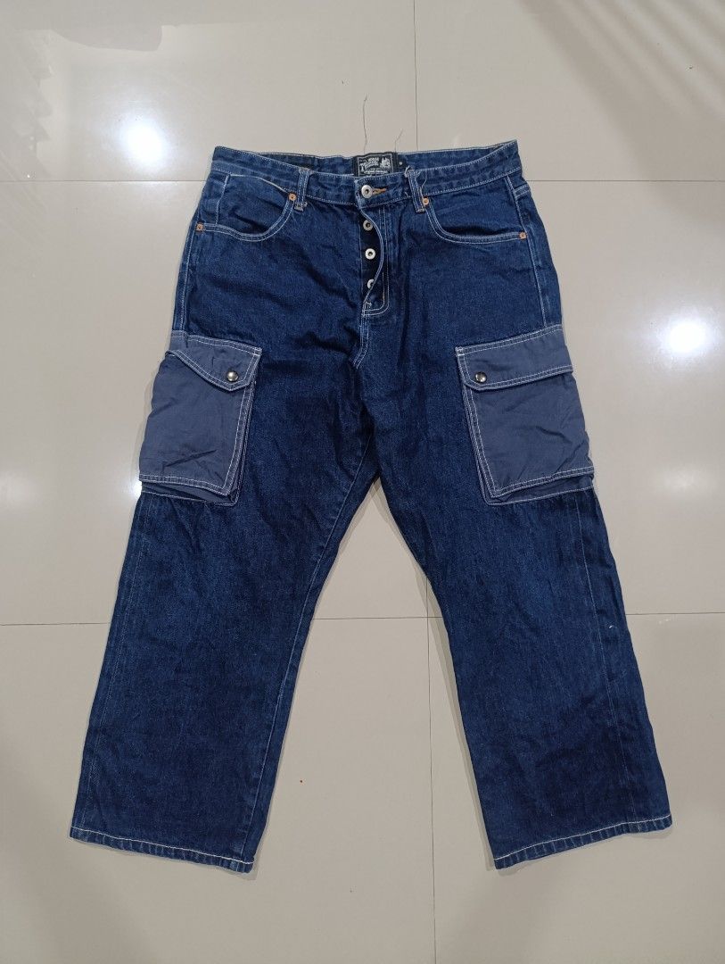 Full House Denim & Workshop Cargo Jeans (Category: Jeans) located in Davao. Submitted by idioticthrifter (Listing ID 1468465588, Image 1). Description: Dark blue denim cargo jeans from Full House Denim & Workshop. Button fly closure, back cinch adjuster, and utility pockets on both legs. Contrast white stitching and tan leather patch on the back waistband. Inside lining has printed graphic details. Heavyweight denim fabric. - Measurements: 34 wai