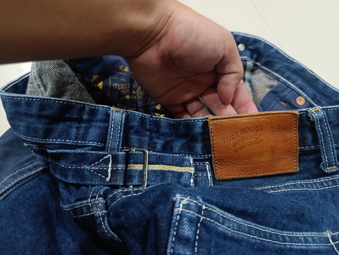 Full House Denim & Workshop Cargo Jeans (Category: Jeans) located in Davao. Submitted by idioticthrifter (Listing ID 1468465588, Image 3). Description: Dark blue denim cargo jeans from Full House Denim & Workshop. Button fly closure, back cinch adjuster, and utility pockets on both legs. Contrast white stitching and tan leather patch on the back waistband. Inside lining has printed graphic details. Heavyweight denim fabric. - Measurements: 34 wai