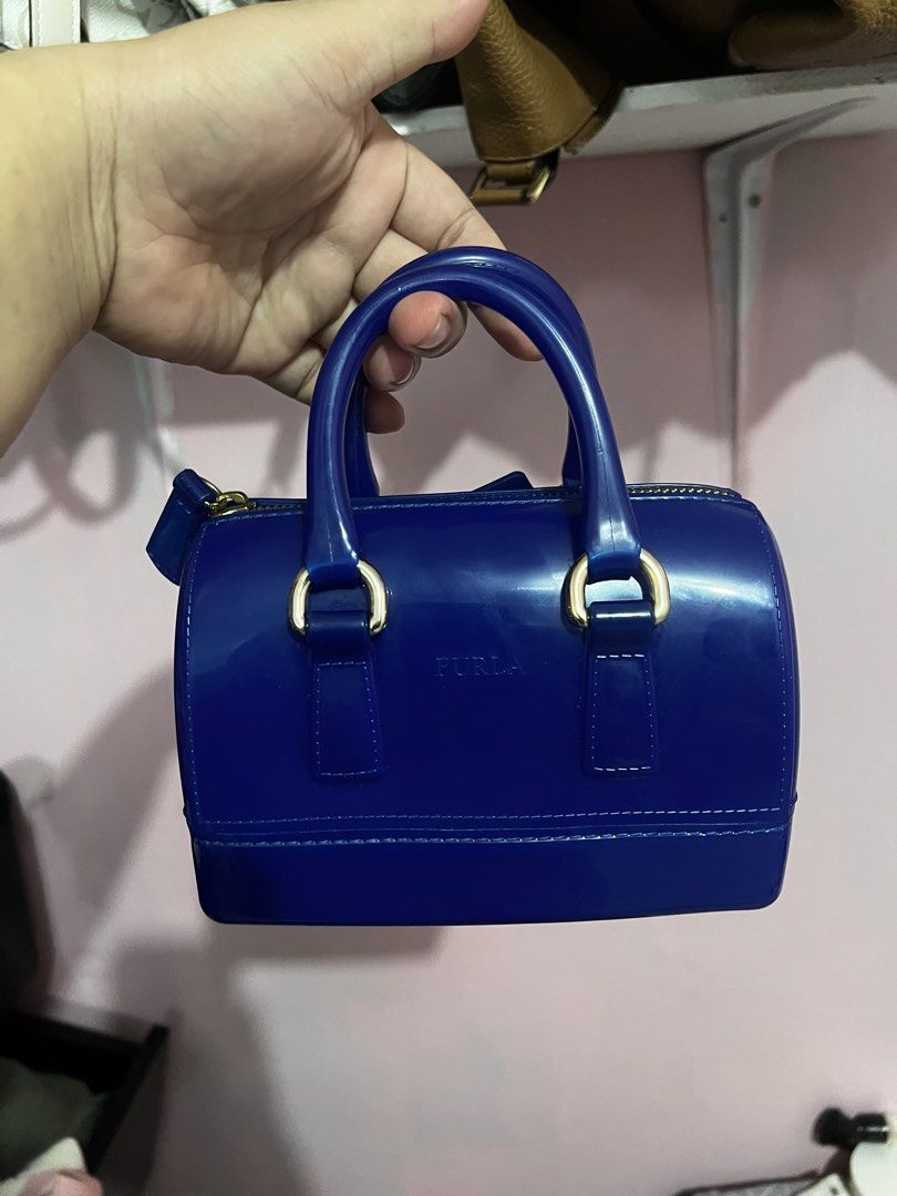 Furla Candy Bag Blue Jelly Handbag (Category: Luxury Bags & Wallets) located in Manila. Submitted by cleverstone_21f597 (Listing ID 1468337663, Image 2). Description: - Authentic Furla Candy Bag in a striking royal blue - Made from durable, glossy jelly material that is easy to wipe clean - Elegant gold-tone hardware with a secure zipper closure - Features double top handles and the matching 'Candy Bag' rubber tag on a ball chain - Structured sha