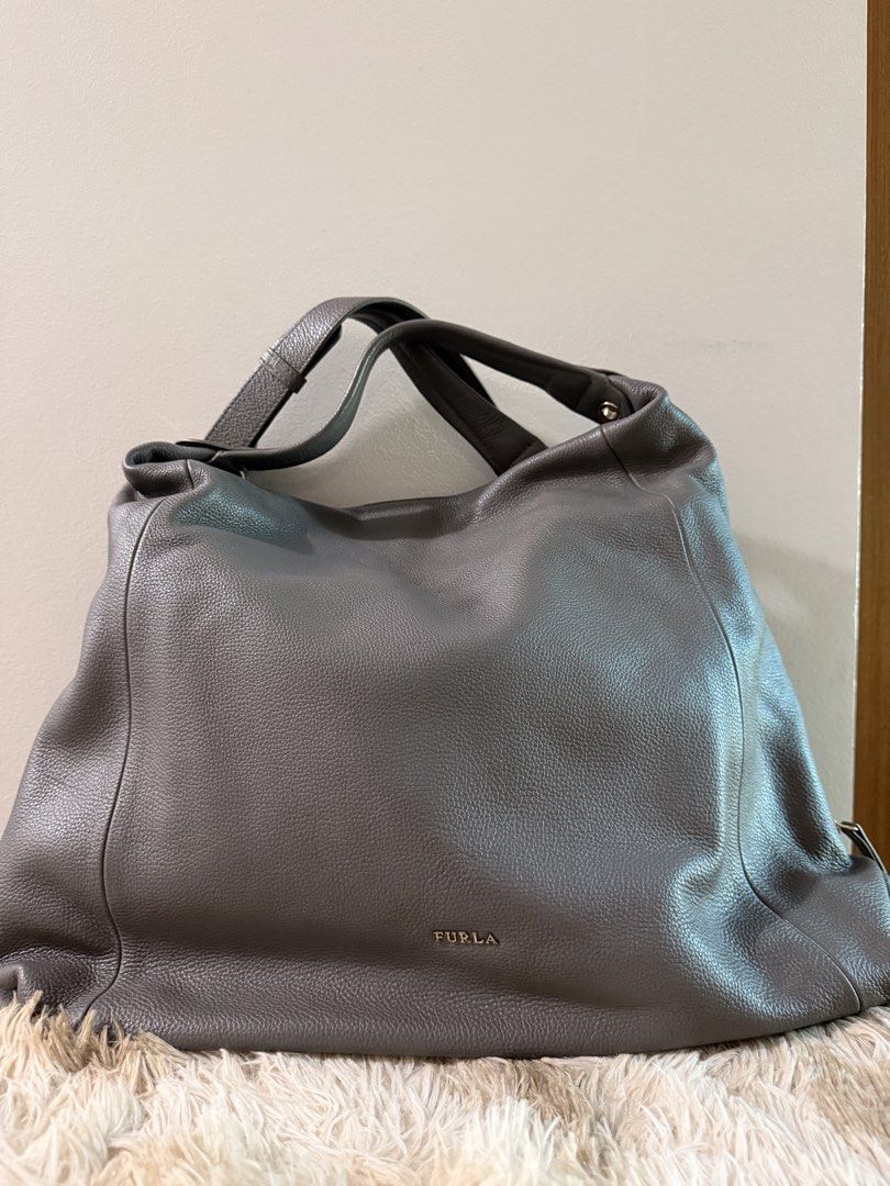 Furla grey pebbled leather hobo shoulder bag (Category: Luxury Bags & Wallets) located in Quezon City. Submitted by rosell.xoxo (Listing ID 1468366589, Image 1). Description: - Brand: Furla - Material: Premium grey pebbled leather - Straps: Comfortable double shoulder straps - Condition: Excellent with dustbag.