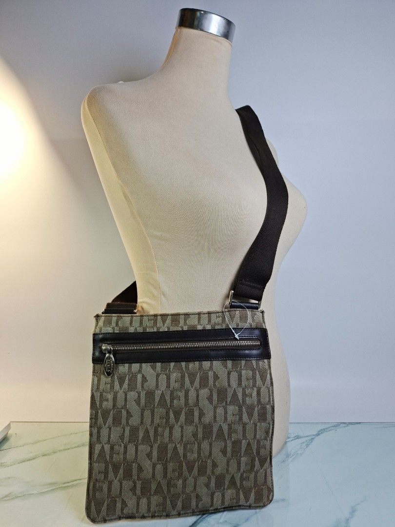 Furla Monogram Crossbody Bag Brown (Category: Luxury Bags & Wallets) located in Pasay City. Submitted by onick_79 (Listing ID 1468462231, Image 2). Description: - Brand: Furla - Style: Compact crossbody / messenger bag - Material: Monogram print canvas with dark brown leather trim - Pockets: Front vertical zipper pocket with branded silver hardware - Strap: Adjustable brown webbed shoulder strap with metal hardware - Condition: Excellent everyday