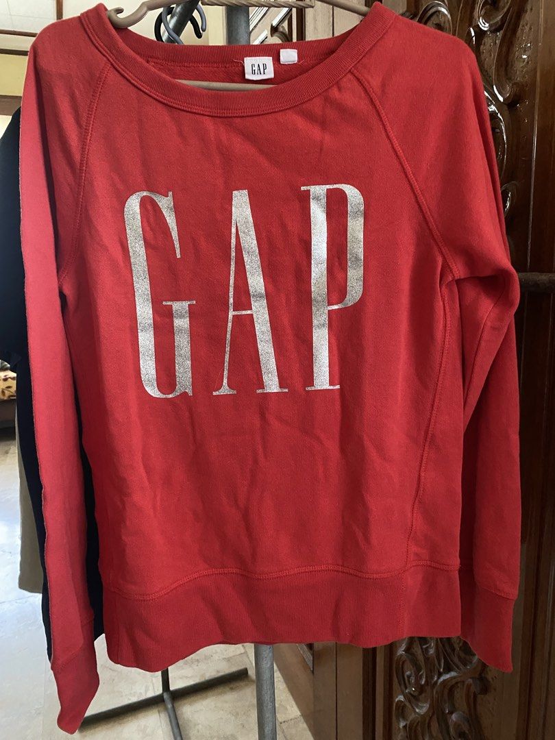 GAP Red Sweatshirt with Silver Logo (Category: Coats, Jackets and Outerwear) located in Manila. Submitted by freestone_f18729 (Listing ID 1468293009, Image 1). Description: - Color: Red - Design: Large silver metallic Gap logo on chest - Fit: Standard fit with long sleeves - Details: Crew neckline, ribbed hem, and small interior Gap brand tag - Material: Soft cotton blend - Condition: Great for casual, everyday outfits.