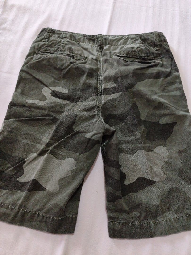 GapKids Camouflage Shorts Size 16 Regular (Category: Babies & Kids Fashion) located in Malungon. Submitted by 2ndhandoriginals (Listing ID 1468304418, Image 2). Description: - Brand: GapKids - Item: Green camo shorts - Size: 16 regular (with adjustable inner waist tabs) - Closure: Classic button and zip fly - Pockets: Two front pockets and two back welt pockets - Material: Sturdy, high-quality cotton - Condition: Excellent everyday wear for growi