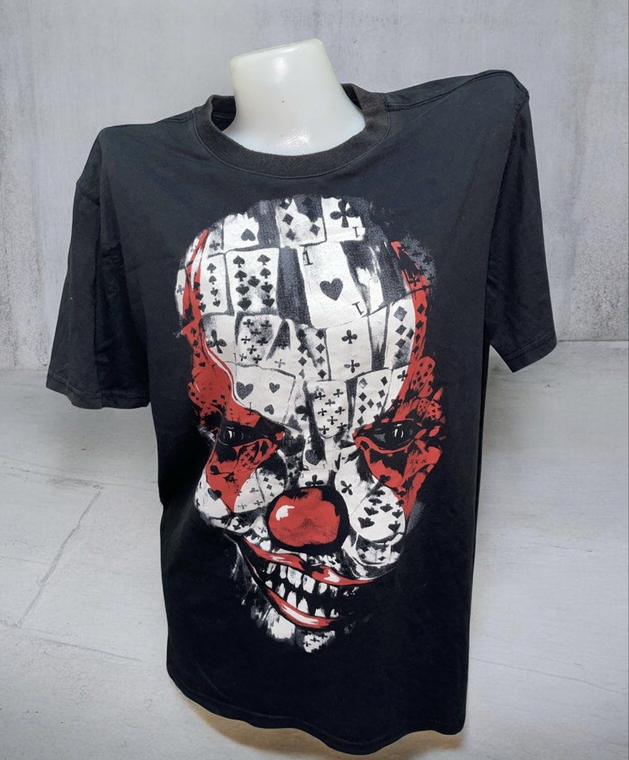 Givenchy Paris Joker Playing Cards Graphic T-Shirt Black (Category: Tshirts & Polo Shirts ) located in Manila. Submitted by fastforest_65f95b (Listing ID 1468334607, Image 1). Description: - Brand: Givenchy Paris - Color: Black - Design: Bold clown face graphic made from playing card designs - Fit & Material: Regular fit, soft cotton fabric - Details: Short sleeves, crew neck - Condition: Minor fading around the collar from normal wear and washin