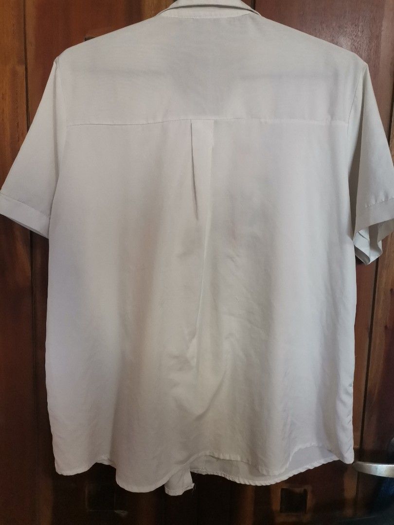 GRACE White Embroidered Short Sleeve Button-Down Shirt (Category: Shirts) located in Makati City. Submitted by kookybearsstuff (Listing ID 1468348584, Image 2). Description: - Brand: GRACE - Style: Short sleeve button-down shirt with standard collar and front button closure - Design: Stunning, colorful floral and hummingbird embroidery on the chest - Details: Chic pleat detail on the back - Material: Lightweight and comfortable fabric - Versatili
