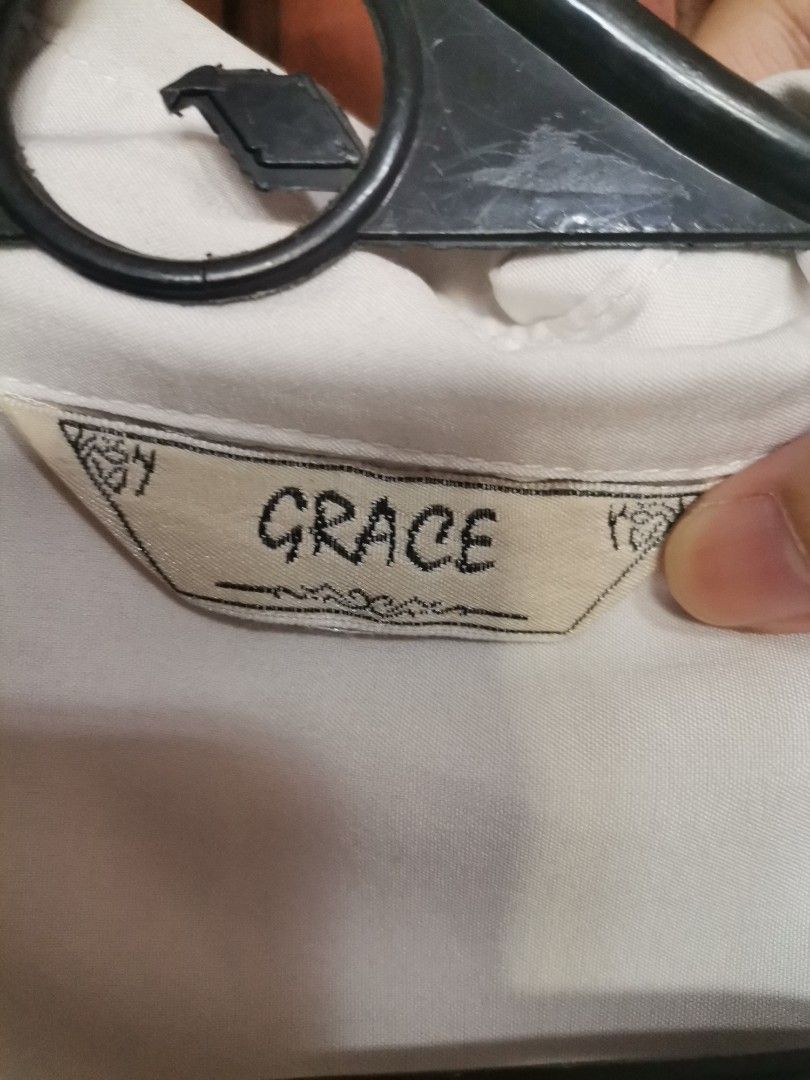 GRACE White Embroidered Short Sleeve Button-Down Shirt (Category: Shirts) located in Makati City. Submitted by kookybearsstuff (Listing ID 1468348584, Image 3). Description: - Brand: GRACE - Style: Short sleeve button-down shirt with standard collar and front button closure - Design: Stunning, colorful floral and hummingbird embroidery on the chest - Details: Chic pleat detail on the back - Material: Lightweight and comfortable fabric - Versatili