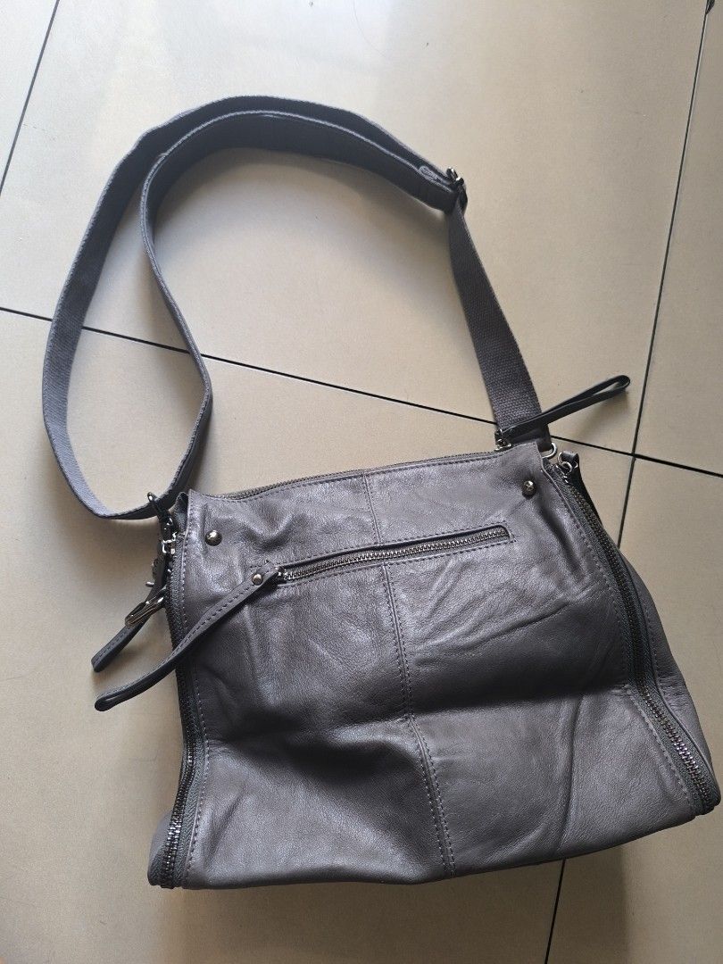 Gray bag edgy design leather unbranded (Category: Cross-body Bags) located in Manila. Submitted by lianlim.mail (Listing ID 1468342049, Image 2). Description: Gray leather bag edgy design unbranded like new clean interior. leather material. adjustable and removable strap zipper closure on top zippers on sides are design only (cannot be unzipped).