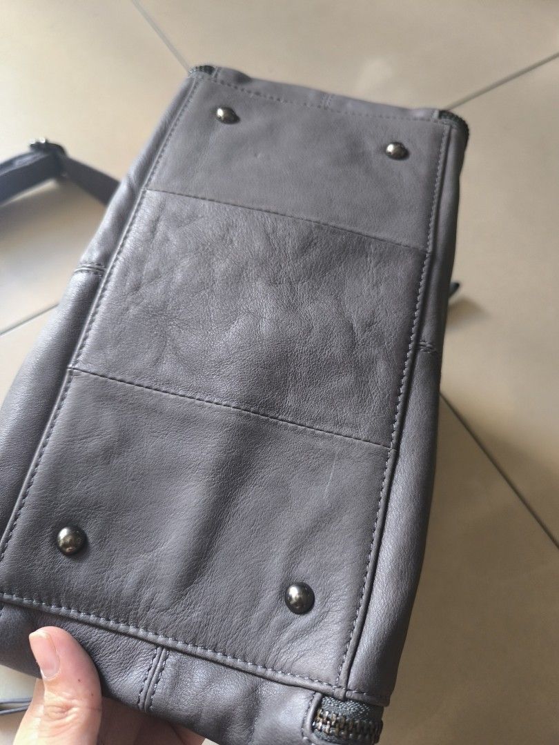 Gray bag edgy design leather unbranded (Category: Cross-body Bags) located in Manila. Submitted by lianlim.mail (Listing ID 1468342049, Image 3). Description: Gray leather bag edgy design unbranded like new clean interior. leather material. adjustable and removable strap zipper closure on top zippers on sides are design only (cannot be unzipped).