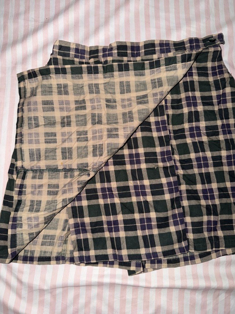 Green Purple Plaid Wrap Skirt (Category: Skirts) located in Taguig. Submitted by deguzmanke83356 (Listing ID 1468361284, Image 2). Description: - Color: Dark green, purple, and beige plaid - Style: Wrap skirt with adjustable button waist closure - Fabric: Lightweight and comfortable - Perfect for: Casual everyday wear or schoolgirl-inspired looks.