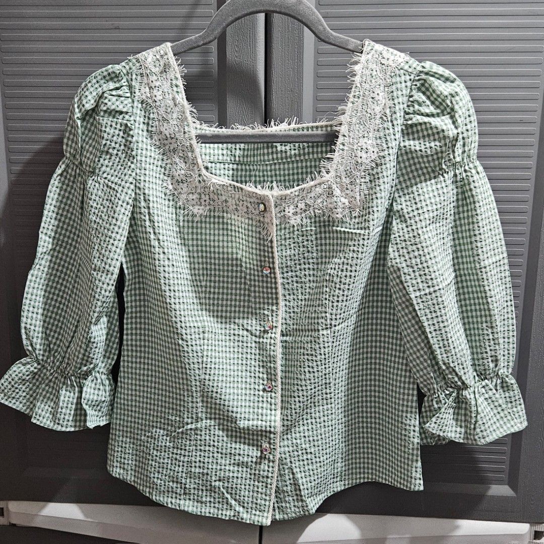 Green White Gingham Check Blouse with Lace Trim (Category: Blouses) located in Quezon City. Submitted by tiamaureia (Listing ID 1468390899, Image 3). Description: - Green and white gingham check blouse with square neckline. - Detailed with white lace trim along the collar and front placket. - Long sleeves with ruffled cuffs. - Buttons down the front with rhinestone embellishments. .