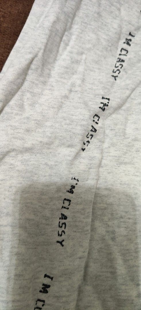 Grey Joggers Sweatpants with Side Lettering Print (Category: Joggers) located in Manila. Submitted by snz_shop (Listing ID 1468472636, Image 2). Description: - Material: Soft and cozy cotton blend - Fit: Tapered fit with cuffed ankles and elastic waistband - Details: Adjustable dark drawstring and bold 'I'M CLASSY' print down the left leg - Pockets: Deep side pockets on both hips - Style: Casual lounge pants, ideal for everyday wear.