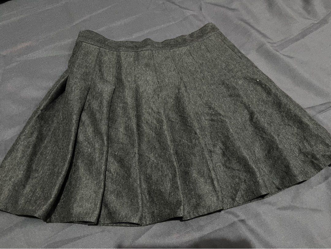 Grey pleated mini skirt (Category: Skirts) located in Quezon City. Submitted by ayapiaya (Listing ID 1468317214, Image 1). Description: W: 26-27 L: 15 - Color: Dark grey (textured heathered thick fabric) - Style: Classic skirt with structured pleats all around - Fit: Clean stitched waistband, mini length - Versatile: Easy to pair with basic tees or cozy sweaters - Condition: Great for casual wear / Daily OOTD.
