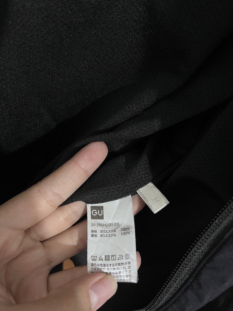 GU Black Hooded Windbreaker Jacket Size M (Category: Coats, Jackets and Outerwear) located in Baguio. Submitted by gbwardrobe (Listing ID 1468332735, Image 2). Description: - Brand/Model: GU Black Hooded Windbreaker - Size: Medium (tag attached) - Material: 100% polyester (outer shell and lining) - Features: Full front zip closure, adjustable drawstrings on the hood - Fit: Lightweight layer, easy to throw on for breezy weather.