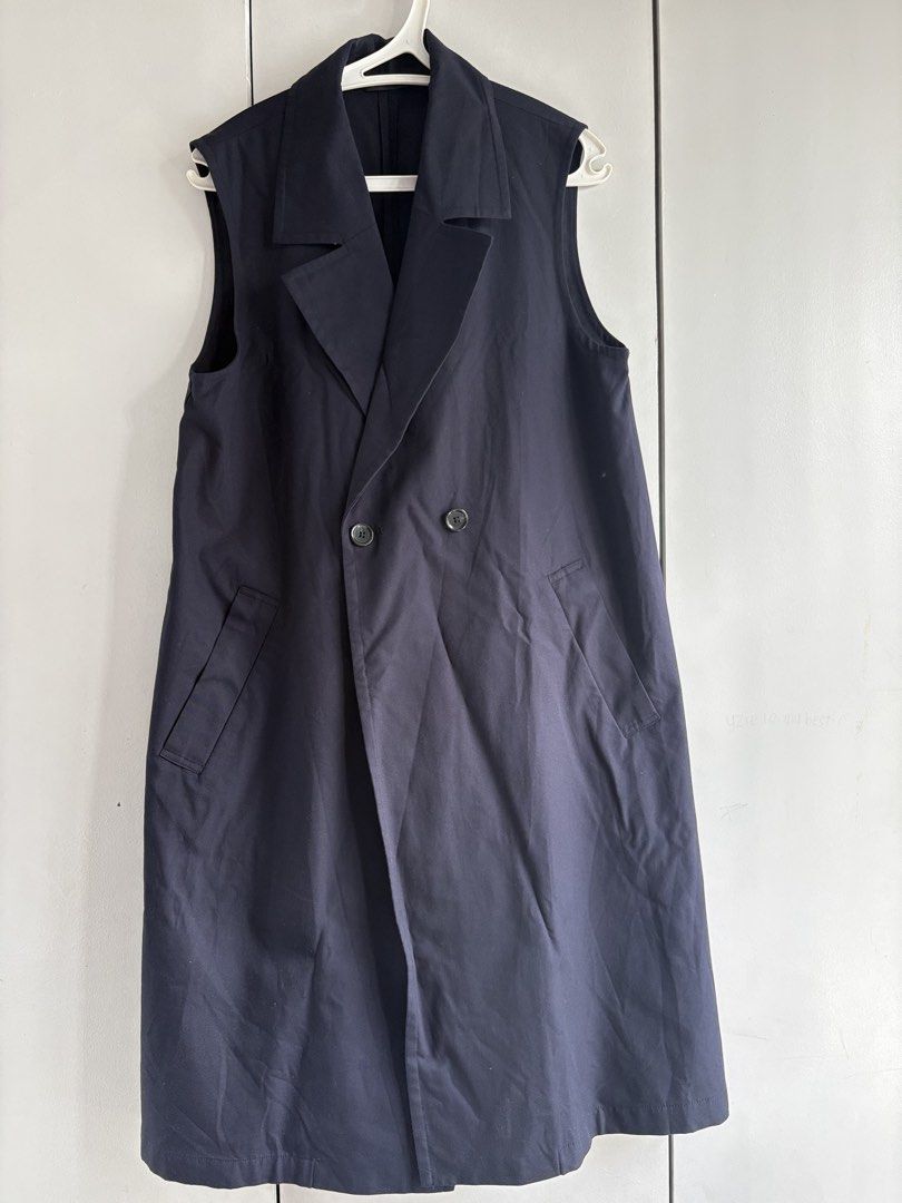 GU Sleeveless Trench Coat (Category: Coats, Jackets and Outerwear) located in Marikina City. Submitted by igmtsisters (Listing ID 1468305232, Image 1). Description: GU Double-Breasted Long Gilet / Sleeveless Trench Coat in navy • Design Type: A sleeveless tailored outer layer (gilet/vest) that blends classic trench and blazer elements. It features a double-breasted closure with front buttons, a clean notched lapel collar, and slanted side welt po