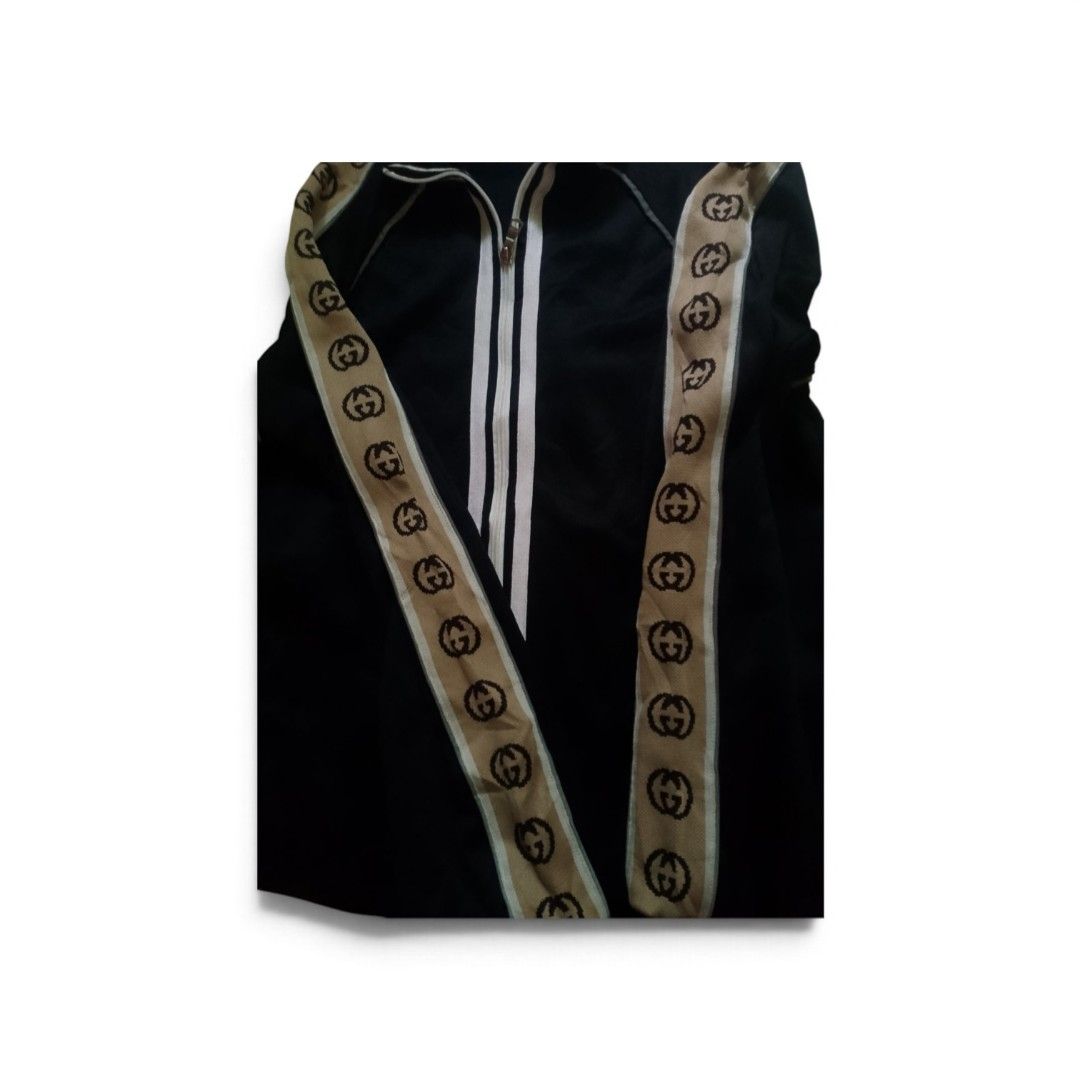 Gucci Black Interlocking G Track Jacket Size M (Category: Coats, Jackets and Outerwear) located in Bacolod City. Submitted by rodzthrift (Listing ID 1468323723, Image 3). Description: - Brand: Gucci - Color: Black with beige and brown GG jacquard tape - Size: Medium (tag attached) - Material: Premium cotton - Features: Double zip front with white stripes, reflective shoulder piping, and adjustable drawstring hem - Origin: Made in Italy - Conditio