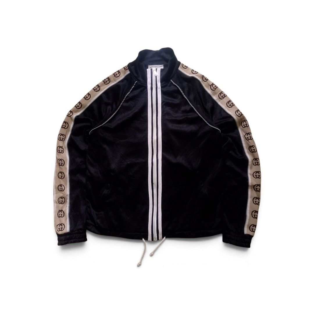 Gucci Black Interlocking G Track Jacket Size M (Category: Coats, Jackets and Outerwear) located in Bacolod City. Submitted by rodzthrift (Listing ID 1468323723, Image 1). Description: - Brand: Gucci - Color: Black with beige and brown GG jacquard tape - Size: Medium (tag attached) - Material: Premium cotton - Features: Double zip front with white stripes, reflective shoulder piping, and adjustable drawstring hem - Origin: Made in Italy - Conditio