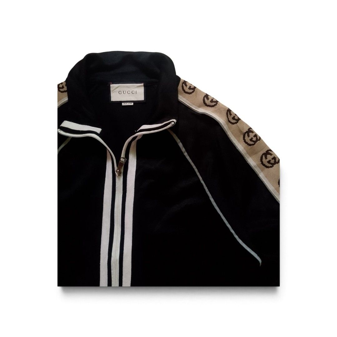 Gucci Black Interlocking G Track Jacket Size M (Category: Coats, Jackets and Outerwear) located in Bacolod City. Submitted by rodzthrift (Listing ID 1468323723, Image 2). Description: - Brand: Gucci - Color: Black with beige and brown GG jacquard tape - Size: Medium (tag attached) - Material: Premium cotton - Features: Double zip front with white stripes, reflective shoulder piping, and adjustable drawstring hem - Origin: Made in Italy - Conditio