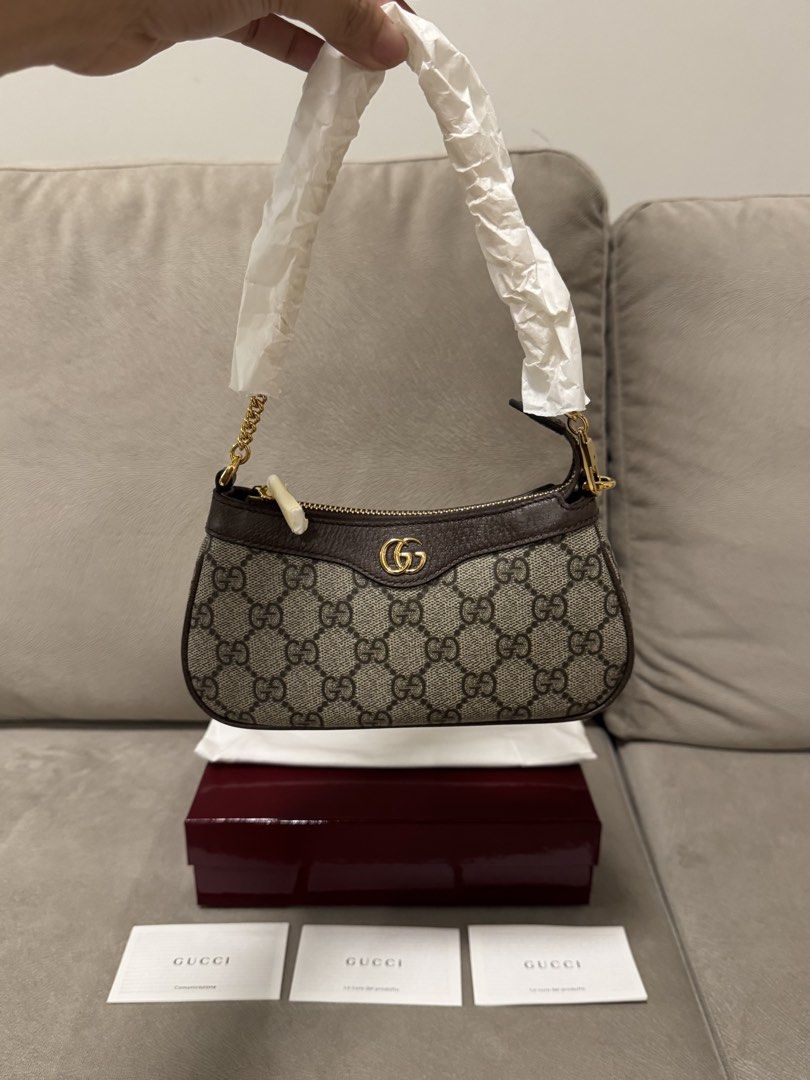 Gucci GG Supreme Mini (Category: Luxury Bags & Wallets) located in Taguig. Submitted by byebyebabies (Listing ID 1468301682, Image 1). Description: - Authentic Gucci GG Supreme canvas mini handbag in unused condition - Classic monogram pattern with brown leather trim and gold-tone hardware - Features the iconic interlocking GG logo on the front and secure zipper closure - Chain handle and zipper still wrapped in original protective paper - Includ