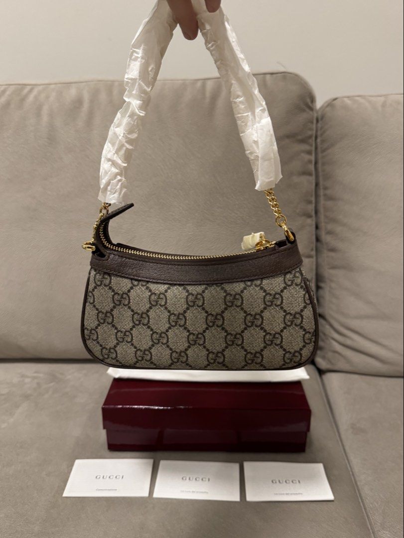 Gucci GG Supreme Mini (Category: Luxury Bags & Wallets) located in Taguig. Submitted by byebyebabies (Listing ID 1468301682, Image 2). Description: - Authentic Gucci GG Supreme canvas mini handbag in unused condition - Classic monogram pattern with brown leather trim and gold-tone hardware - Features the iconic interlocking GG logo on the front and secure zipper closure - Chain handle and zipper still wrapped in original protective paper - Includ