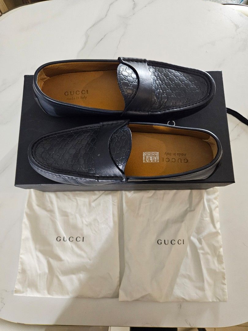 GUCCI Guccissima Dark Blue Loafers (Category: Dress Shoes) located in Mandaue City. Submitted by robertnpompompurin (Listing ID 1468320177, Image 1). Description: Was given as a graduation gift. Tried it twicw and realised it wasn't my style. Gucci Guccissima Dark Blue Moccasins - Color & Material: Dark Blue leather with debossed micro-GG pattern - Details: Leather strap, gold interior branding, Made in Italy - Condition: Minor creasing from hand
