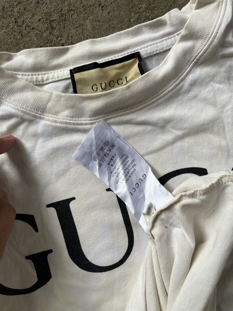 Gucci Interlocking G Logo White T-Shirt (Category: Shirts) located in Calabanga. Submitted by jijithriftcamarinessur (Listing ID 1468314942, Image 3). Description: - Brand: Gucci - Color: White with large black chest logo - Material: 93% cotton, 7% elastane blend for extra comfort - Fit: Standard fit, classic crew neck, short sleeves - Origin: Made in Italy - Condition: Clean look, bold branding - Shipping or meetups available across the Philippi