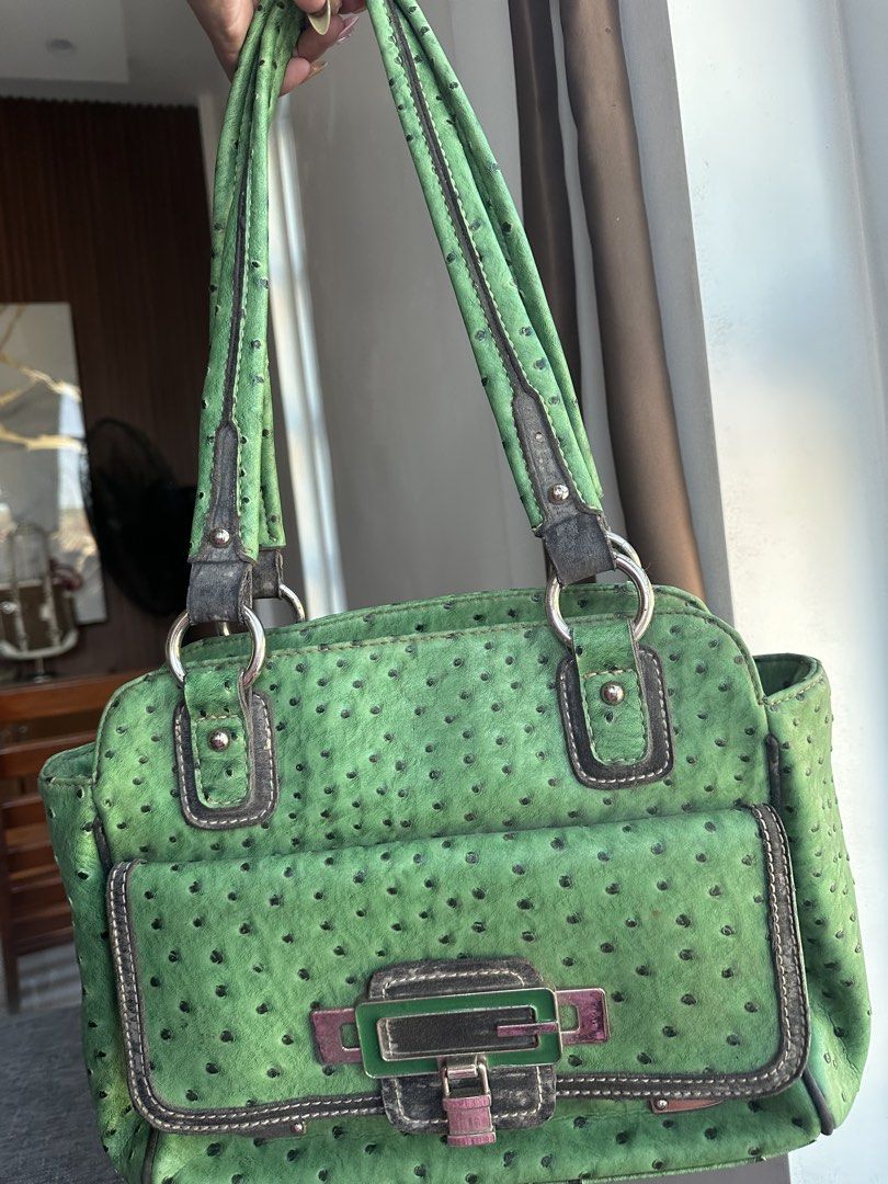 Guess Green Ostrich Leather Texture Handbag (Category: Shoulder Bags) located in Manila. Submitted by goldenhorse-dafc (Listing ID 1468343775, Image 1). Description: - Brand: Guess - Material: Green ostrich leather texture - Closure & Front: Flap pocket with metal logo buckle - Straps & Hardware: Dual shoulder straps with silver-toned rings - Exterior Storage: Convenient back zip pocket - Interior: Patterned fabric lining with multiple compartmen