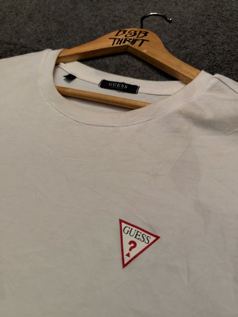 Guess Los Angeles Shirt (Category: Tshirts & Polo Shirts ) located in Cordova. Submitted by bsb.streetluxvintage.clothing (Listing ID 1468424635, Image 2). Description: - Brand: Guess Los Angeles - Color: White - Size: XXL (Standard Fit) - Material: 100% Cotton - Design: Classic crew neck with short sleeves - Detail: Iconic embroidered Guess triangle logo on the chest - Style Number: KP2K9423 - Condition: Great everyday staple piece.