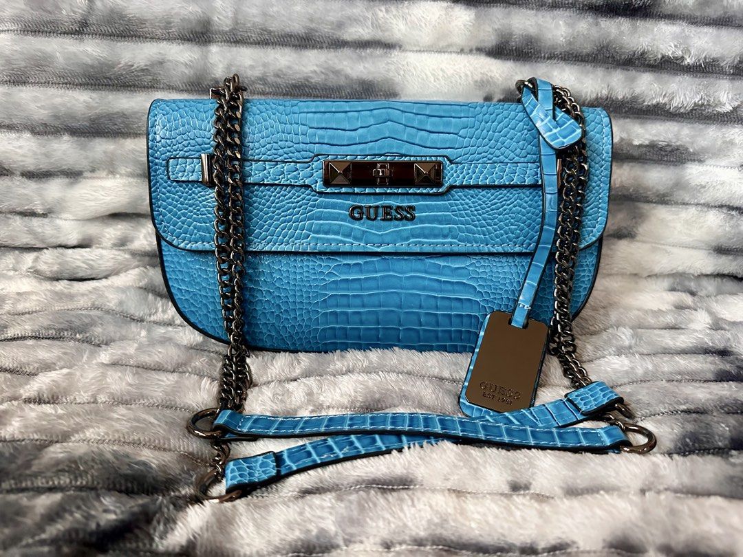 Guess Y2K Bag (Category: Shoulder Bags) located in Bacoor. Submitted by jianne_preloved (Listing ID 1468388106, Image 1). Description: Selling my Guess Y2K bag. Only used twice. No signs of use. 🤗 ✨ ITEM DETAILS: • Brand: Guess • Color/Hardware: Bright blue crocodile embossed w/ Gunmetal hardware • Material: Crocodile embossed leather • Condition: Like New - No flaws 🔎 CONDITION NOTES: • Exterior: Clean, no scratches. No rubbing on edges. • Int