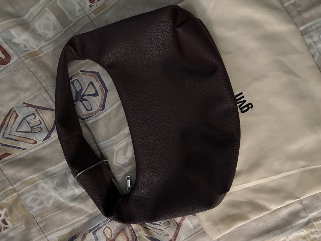 GVN Hobo Bag MEDIUM (Category: Shoulder Bags) located in Quezon City. Submitted by fitfoundbyli (Listing ID 1468289957, Image 3). Description: - Brand: GVN - Style: Slouchy hobo shoulder bag - Material: Textured leather in a rich dark brown shade - Silver-tone zipper closure on top - Compartments: Secure internal zipped pocket with a clean interior lining - Inclusion: Matching beige GVN dust bag included - No flaws, decluttering.