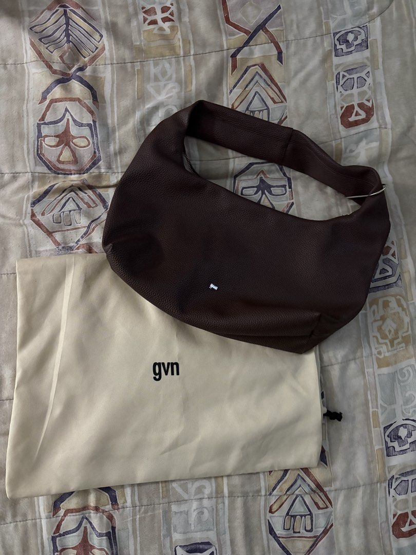 GVN Hobo Bag MEDIUM (Category: Shoulder Bags) located in Quezon City. Submitted by fitfoundbyli (Listing ID 1468289957, Image 1). Description: - Brand: GVN - Style: Slouchy hobo shoulder bag - Material: Textured leather in a rich dark brown shade - Silver-tone zipper closure on top - Compartments: Secure internal zipped pocket with a clean interior lining - Inclusion: Matching beige GVN dust bag included - No flaws, decluttering.