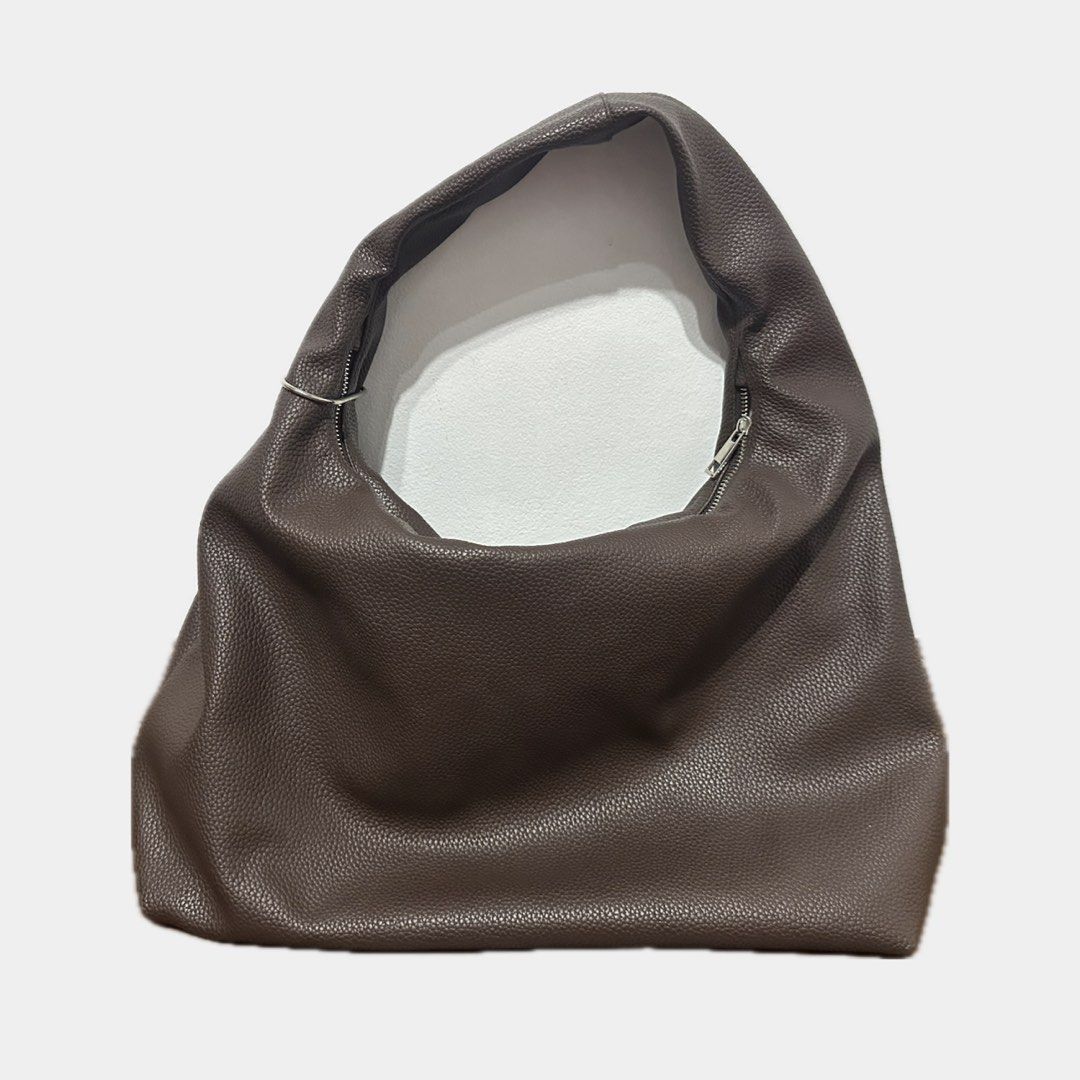GVN hobo bag in Espresso (Category: Shoulder Bags) located in Paranaque City. Submitted by annvzsn (Listing ID 1468498504, Image 2). Description: Color: espresso Size: large Material: heavy pebbled leather Bought in: PH (official website) Condition: well used Details: - Spacious interior - Metal one-way zipper closure - Inner zippered pocket - Heavy pebbled leather - Carabiner, outer D-ring, logo emblem ♡ My go to uni bag; it actually holds a lot