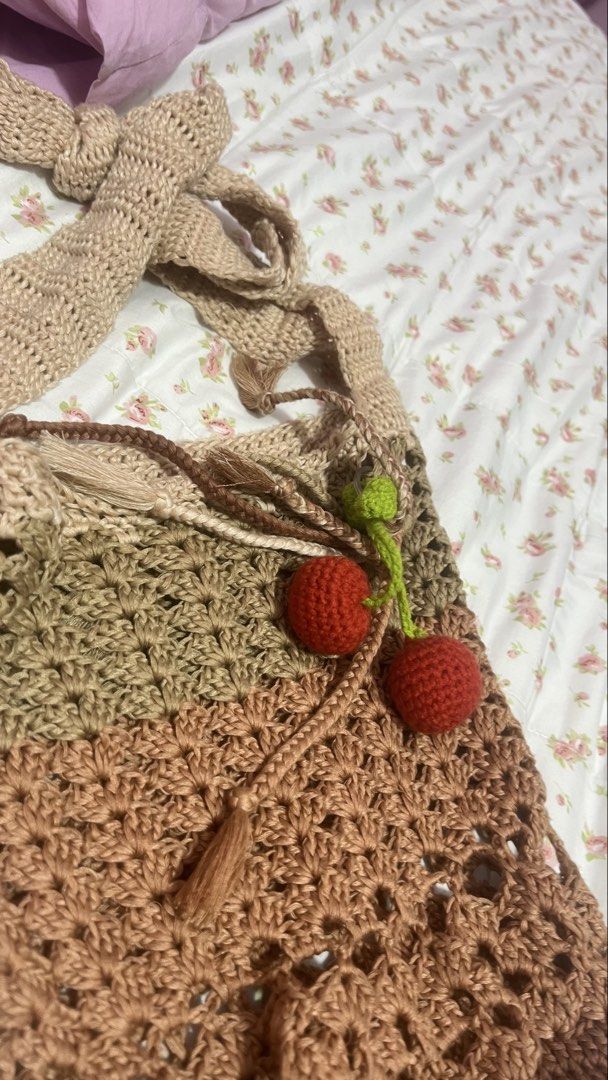 Handmade crochet shoulder bag with cherry charms (Category: Shoulder Bags) located in Pasig City. Submitted by morilove (Listing ID 1468302109, Image 2). Description: - Handmade crochet shoulder bag in a stylish earth-tone, graduated brown and beige colorway - Features a trendy openwork stitch pattern and a wide, super comfortable braided strap - Comes with adorable detachable crochet cherry charms - Perfect everyday size for carrying your daily 