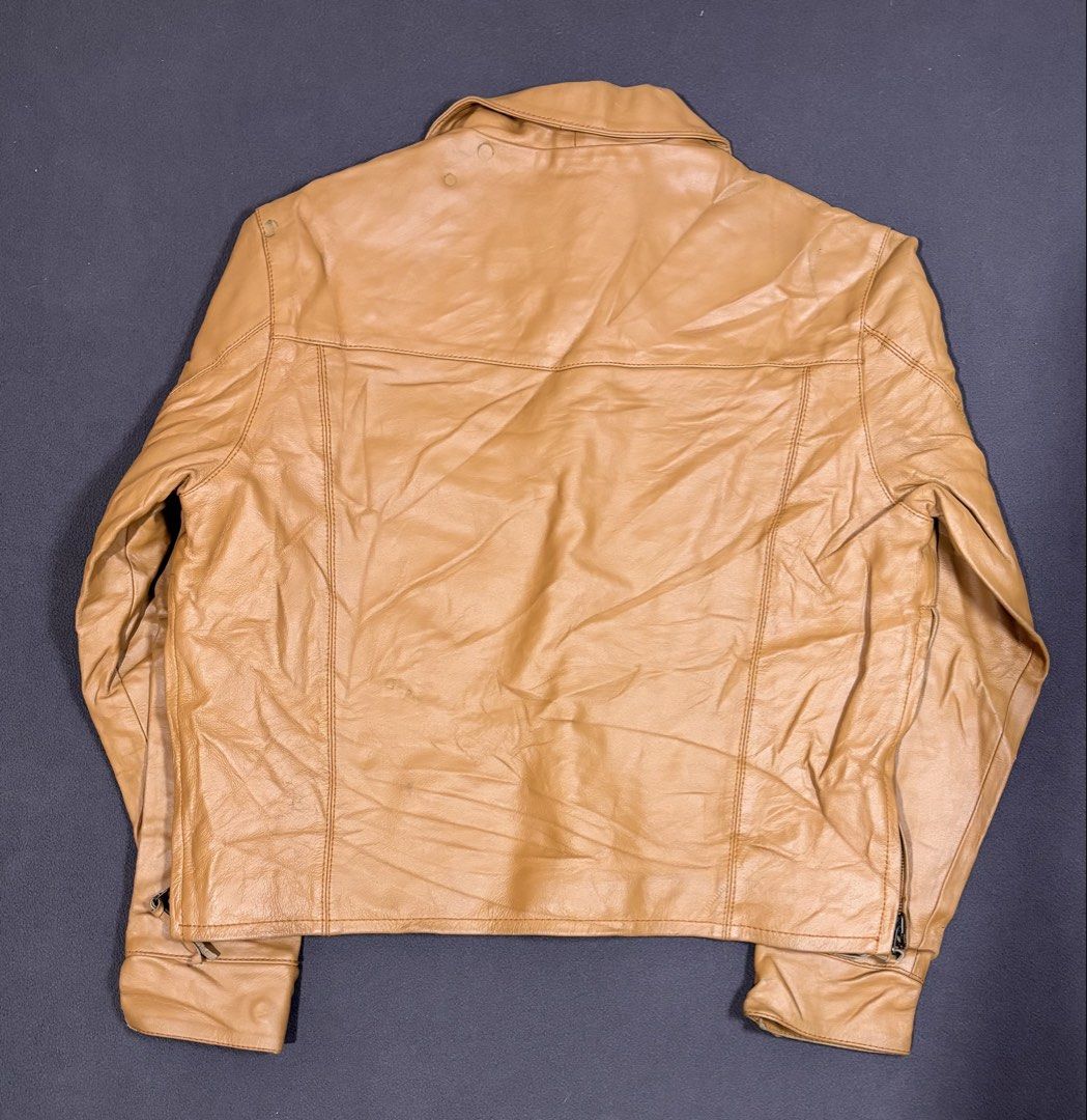 Harley Davidson Tan Leather Jacket Lace-Up Front Size L (Category: Coats, Jackets and Outerwear) located in Mabalacat. Submitted by _limitlessfashion (Listing ID 1468309827, Image 2). Description: - Brand: Vintage Harley-Davidson - Size: Large - Length 23 - Width 23 - No major issue, sign of use only - Color: Tan with natural vintage creasing and wear lines - Material: Genuine leather with cozy quilted lining - Closure/Neck: Front lace-up detail 